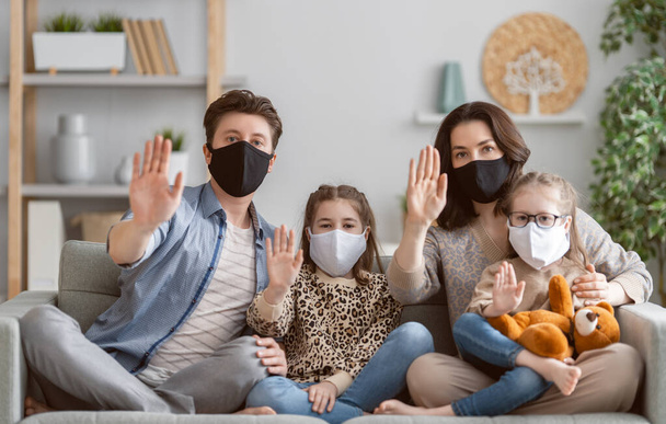 Family is wearing facemasks during coronavirus and flu outbreak. Virus and illness protection, quarantine. COVID-2019. A call to stay at home - Φωτογραφία, εικόνα
