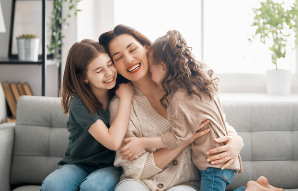 Happy mother's day! Mom and her daughters children girls are playing, smiling and hugging. Family holiday and togetherness.      - Foto, Imagem