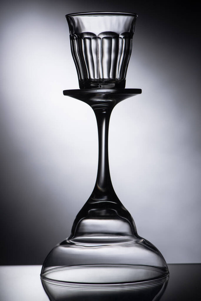 empty shot glass on cocktail glass on dark background - 写真・画像