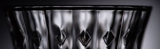 close up view of empty faceted shot glass on dark background, panoramic shot - Foto, Imagem