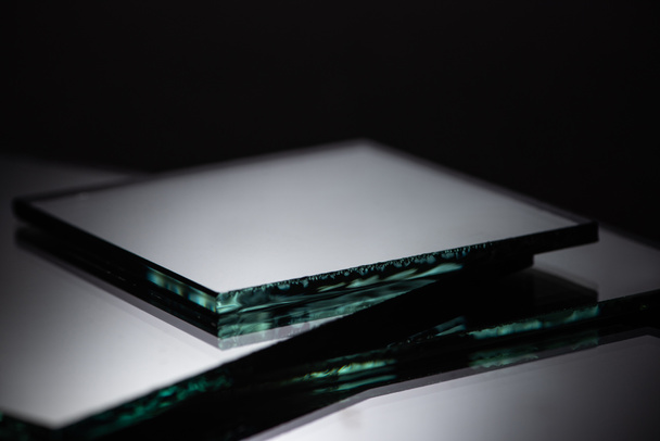 close up view of square mirror pieces in stack on black - Foto, Imagem