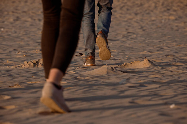 Feet of people walking on the sand - Fotó, kép