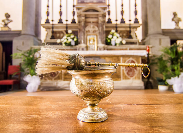 kirkon sisällä papin siunaama vesi valmiina kastetta, ehtoollista, joulua, konfirmaatiota, avioliittoa, hautajaisia ja pyhää massaa varten
 - Valokuva, kuva