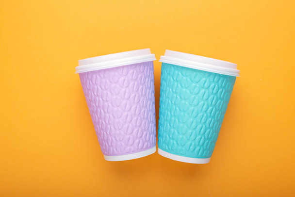 Take-away coffee cups on yellow background. Two coffee to go cups, mockup. - Photo, Image