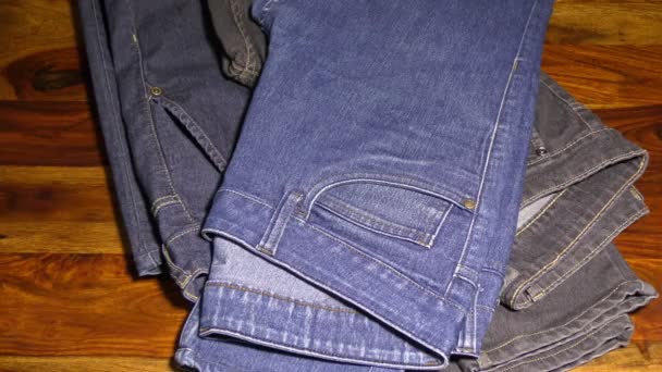 Stacking and removing jeans from table top - Footage, Video