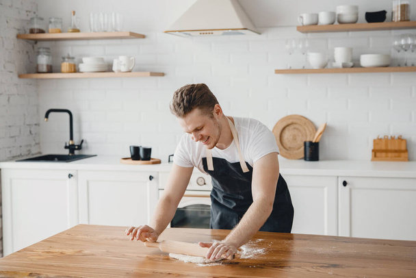 Chef hands rolling pizza dough on light kitchen background - Photo, Image
