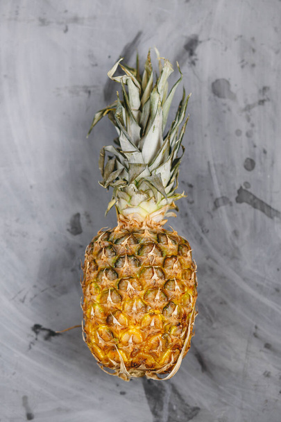 Ripe Whole Pineapple on Grey Concrete Background - Foto, Imagen