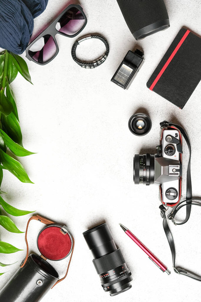 Set of photo accessories with a retro camera on a light background.Travel vacation concept. Summer background. Top view copy space. - Photo, Image