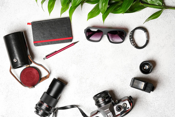 Set of photo accessories with a retro camera on a light background.Utazás nyaralás koncepció. Nyári háttér. Felülnézet másolási hely. - Fotó, kép