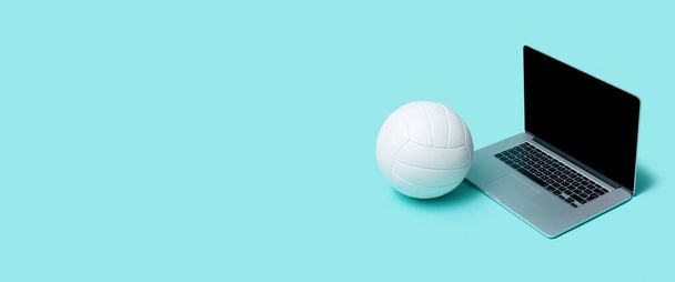 Laptop With Volleyball Ball On Blue color background. Workout online concept - Photo, Image
