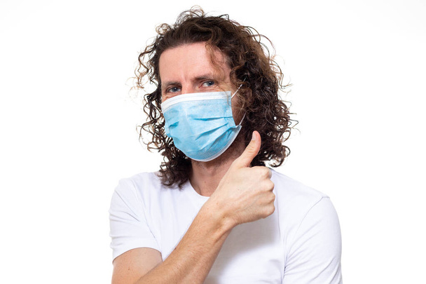 Man in medical mask. Pandemic coronavirus epidemic covid-19 - Photo, Image