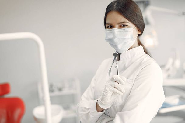 Beautiful dentist working on a dental clinic - Photo, image