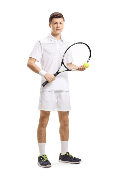 Male tennis player standing and holding a ball and a racket isolated on white background - Foto, immagini