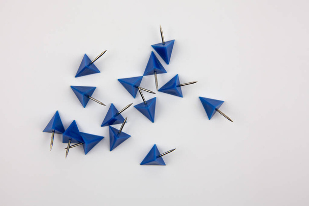 Blue paper pins on a white background. A tool for attaching paper to the wall. - Foto, immagini