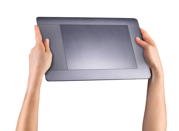 Hand holding graphic tablet for illustrators, designers and photographers isolated on white background with clipping path - Fotó, kép