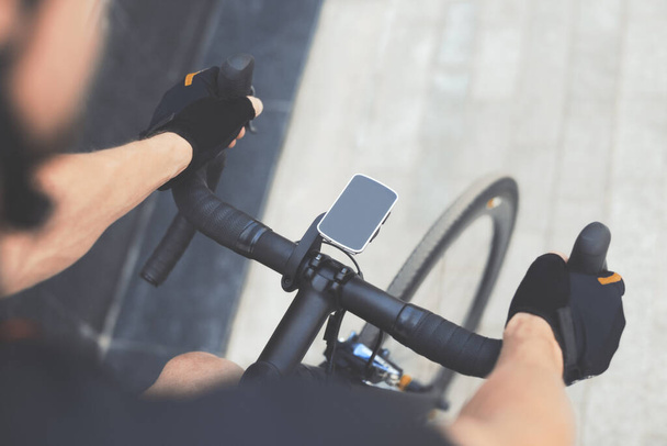 Road Bike With GPS Navigator With Smart Watches on Cycle Handle Bar. Blank Screen With Copy Space. Cyclist Man Riding Sport Bike At City. Concept of Environmental Friendly Alternative Transportation - Fotografie, Obrázek