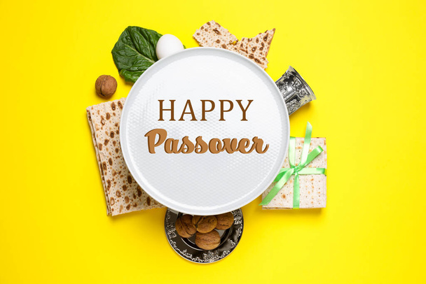 Symbolic Passover items on yellow background, flat lay. Pesah celebration - Photo, Image