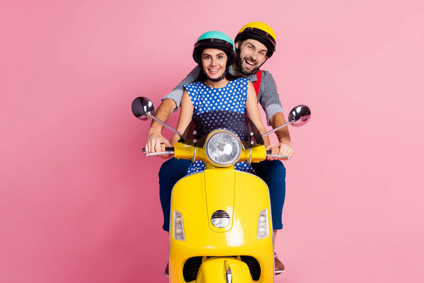 Portrait of his he her she nice attractive cheerful cheery couple driving moped spending time vacation holiday weekend isolated over pink pastel color background - Zdjęcie, obraz