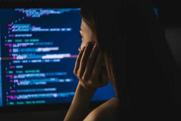 Young female programmer writes program code on a computer.  - Фото, зображення