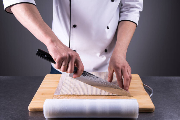 chef prepares makisu for fresh sushi in a restaurant kitchen13 - 写真・画像