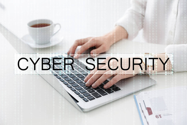 Cyber security concept. Woman working with laptop at table indoors, closeup - Photo, Image