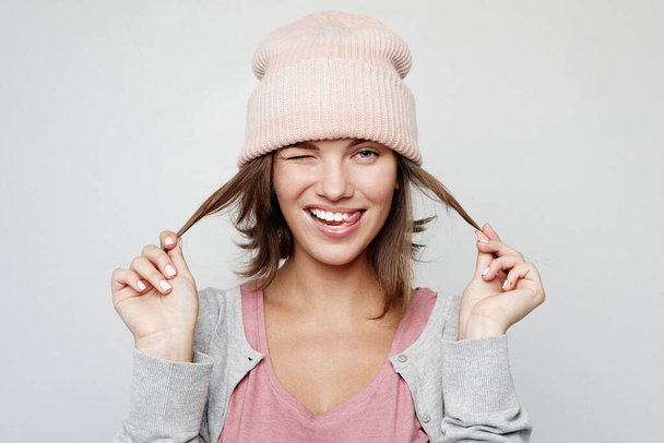 lifestyle, emotion and people concept - happy young emotional woman wearing pink hat - Фото, изображение