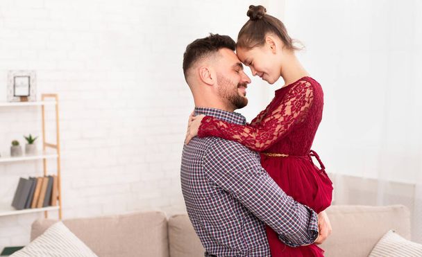 Happy dad and daughter embracing at home, empty space - Photo, Image