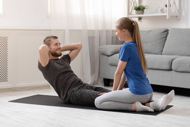 Young couple training at home on quarantine, free space - Foto, Imagen