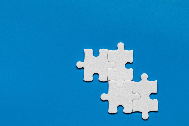 Closeup of jigsaw puzzle isolated. Missing jigsaw puzzle piece, business concept for completing the puzzle piece. Group of puzzle and a puzzle piece. Teamwork concept. Think difference concept.  - Фото, изображение