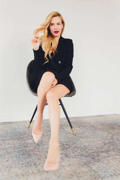Blonde business woman in a black suit. - Photo, image