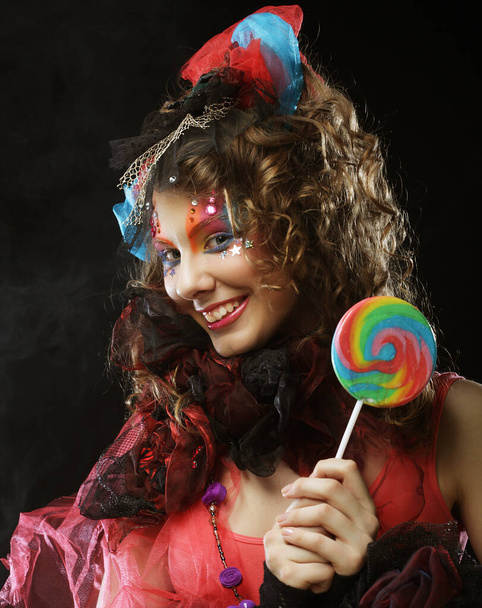 Girl with with creative make-up holds lollipop. Doll style. - Valokuva, kuva