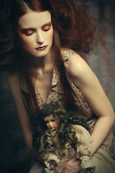 Beautiful lady with artistic make-up with doll - Valokuva, kuva