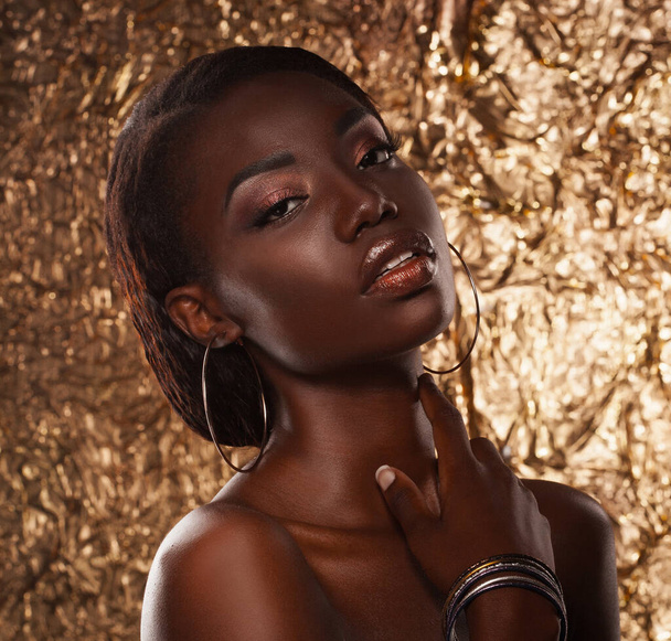 portrait of sensual young african woman against golden background - Valokuva, kuva
