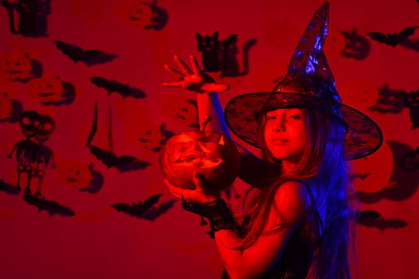 Halloween party and decorations concept. Little witch wearing black hat - Foto, Imagem