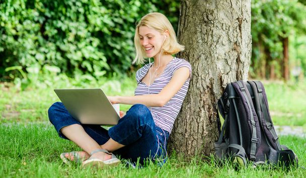 Girl work with laptop in park. Reasons why you should take your work outside. Lunch time relax or coffee break. Nature is essential to wellbeing and ability to be productive. Work in summer park - Photo, Image