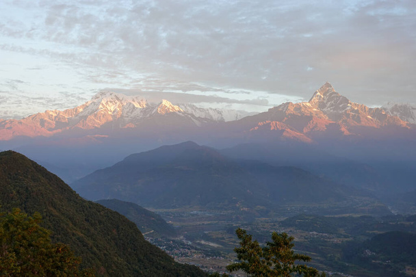The beautiful colors of the morning light shining on the Himalaya Mountains of Nepal. - Photo, Image