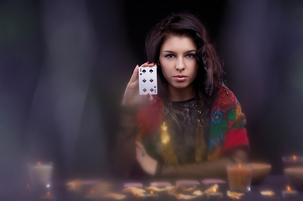 Attractive young fortune teller holdin card - Foto, immagini