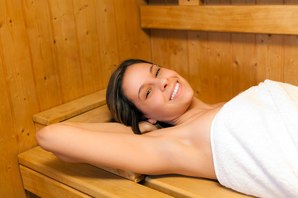 Woman relaxing in sauna - 写真・画像