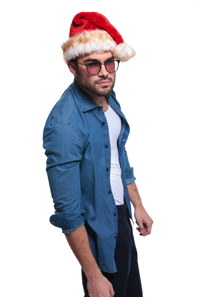 side view of an angry man in santa claus hat - Photo, Image