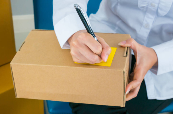 Start up owner small business with many parcel package are Writing customer Address before shipping with Check list paper at workplace online Értékesítési koncepció - Fotó, kép