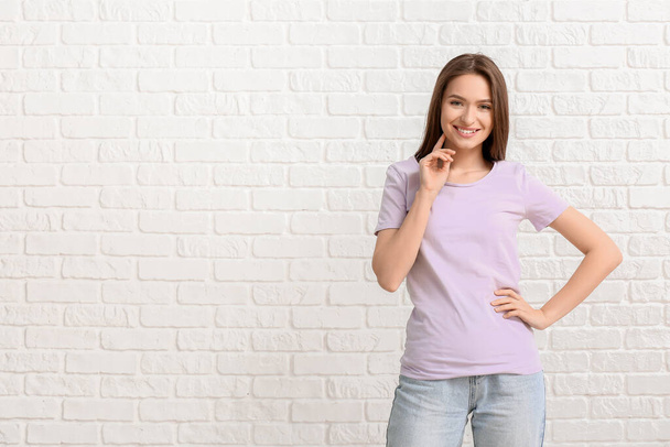 Young woman in stylish t-shirt on white background - Fotografie, Obrázek