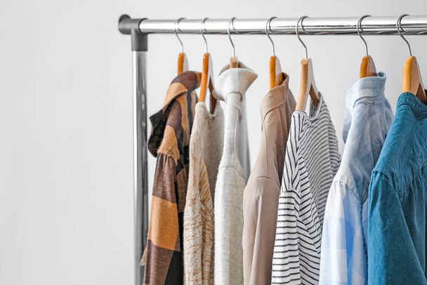 Rack with clothes on light background - Photo, Image