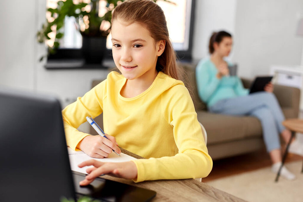 student girl with laptop learning online at home - Foto, imagen