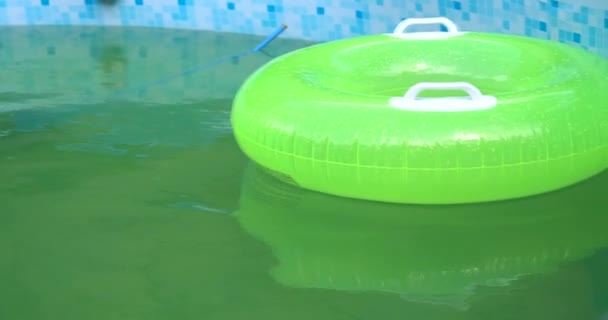 Swimming pool with a brightly green inflatable ring - Footage, Video