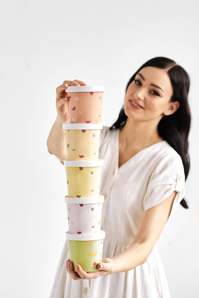 Woman with tower of paper boxes. Takeaway package design layout. - 写真・画像