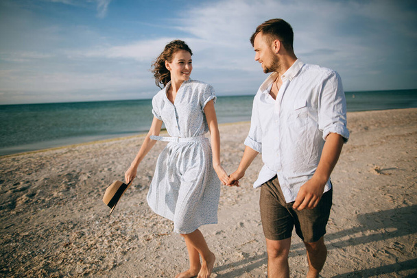 Loving happy young couple walking on the beach. Summer vacation - Fotoğraf, Görsel