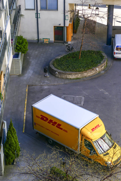 Stockholm, Sweden  A DHL delivery truck in a residential aprtment building parking lot. - Photo, Image