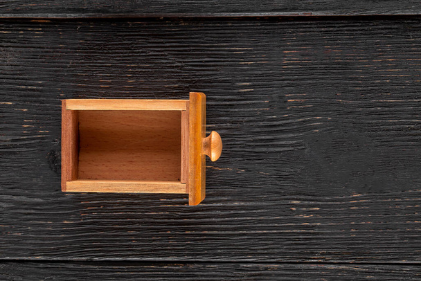 Small wooden box on the dark wooden background - Fotografie, Obrázek