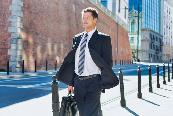 Portrait of mature confident man walking on pavement - Fotografie, Obrázek