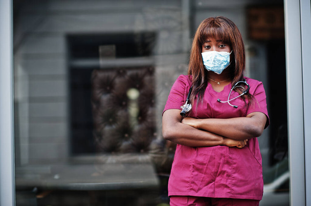 African american female doctor at red lab uniform in protective facial mask. Medicine, profession and healthcare concept. Stop coronavirus infection. - Fotó, kép